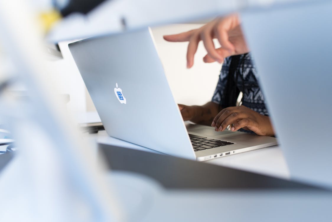 Free Person's Fingers Pointing in Macbook Pro Stock Photo