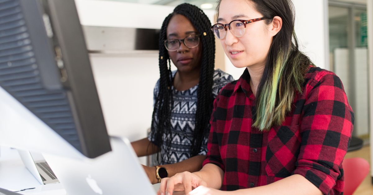 Canadian and Mexican professional reviewing USMCA TN visa work documents for US employment
