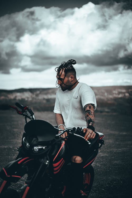 Man in White Shirt Riding a Motorcycle