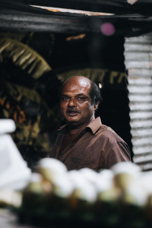 Free A candid portrait of an Indian man with a mustache, wearing a brown shirt, captured indoors. Stock Photo