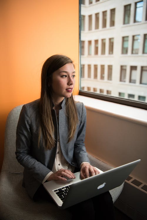 Photography of Woman Using Laptop