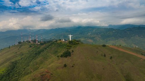 Free Aerial view of Christ the Redeemer statue atop a mountain with scenic landscapes. Stock Photo