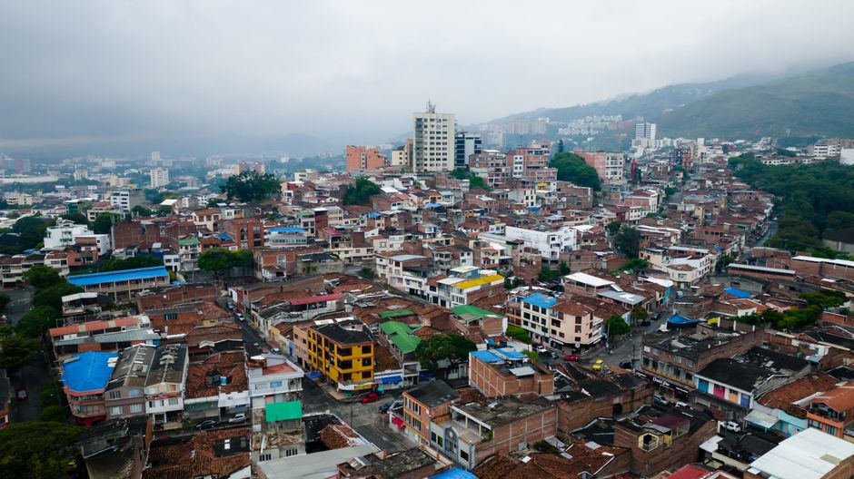 Ultimate Medellín: Guatapé Day Guided Tour & Boat Experience Review 2026 - Aerial view showcasing a vibrant urban landscape with diverse buildings under an overcast sky.