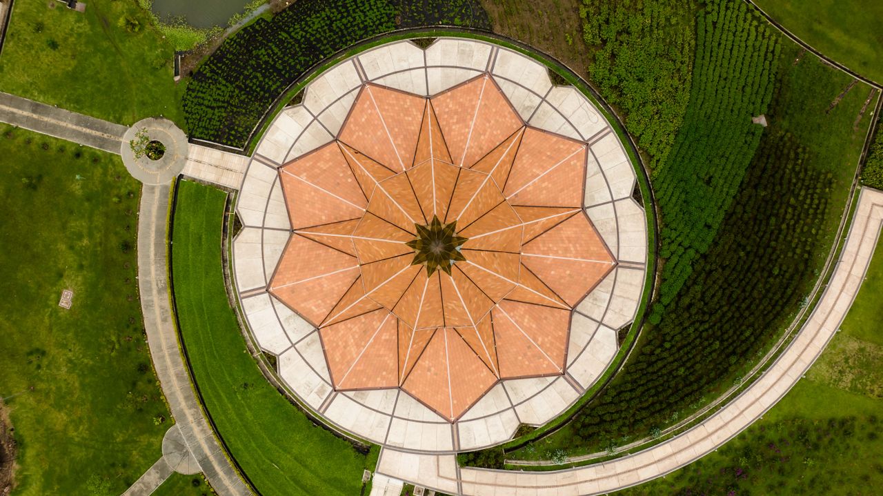 top down aerial view of a circular patterned garden structure with lus