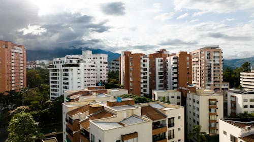White and Brown Concrete Buildings Under White Clouds