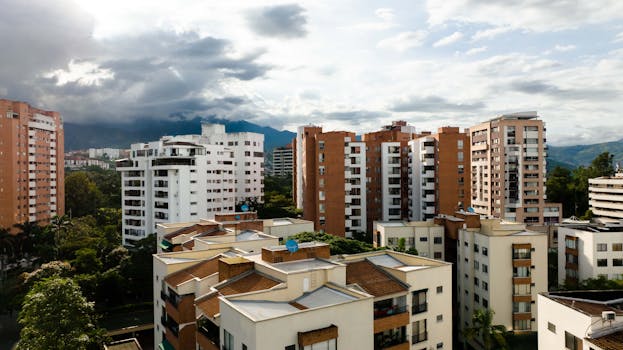 A scenic view of contemporary apartment buildings against a cloudy sky backdrop.