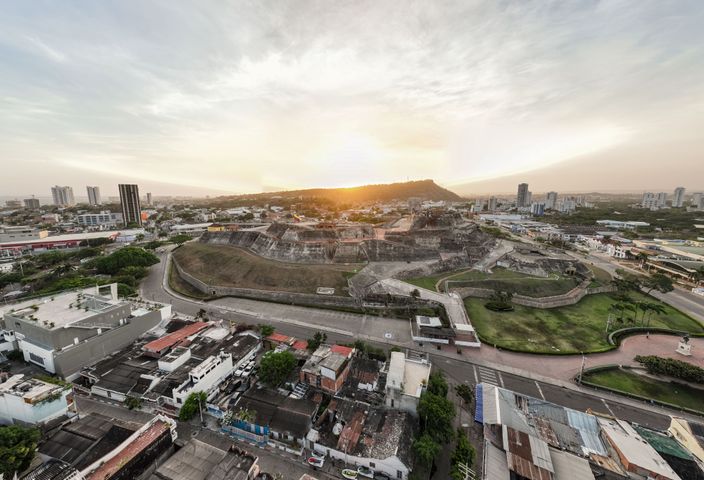 Drone view capturing the scenic sunset over the historic fortress in Cartagena.