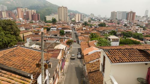 Free Captivating aerial view of a cityscape featuring traditional terracotta roofs and buildings. Stock Photo