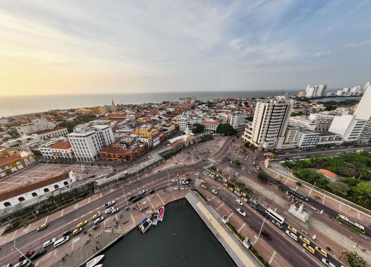 A breathtaking aerial view capturing Cartagena's vibrant streets, historic architecture, and stunning waterfront at sunset.