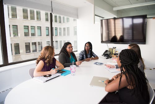 Free Group of Five Women Gathering Inside Office Stock Photo