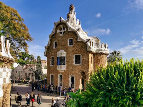 Free Tourists Visiting the Casa del Guarda Gatehouse in Barcelona Spain Stock Photo