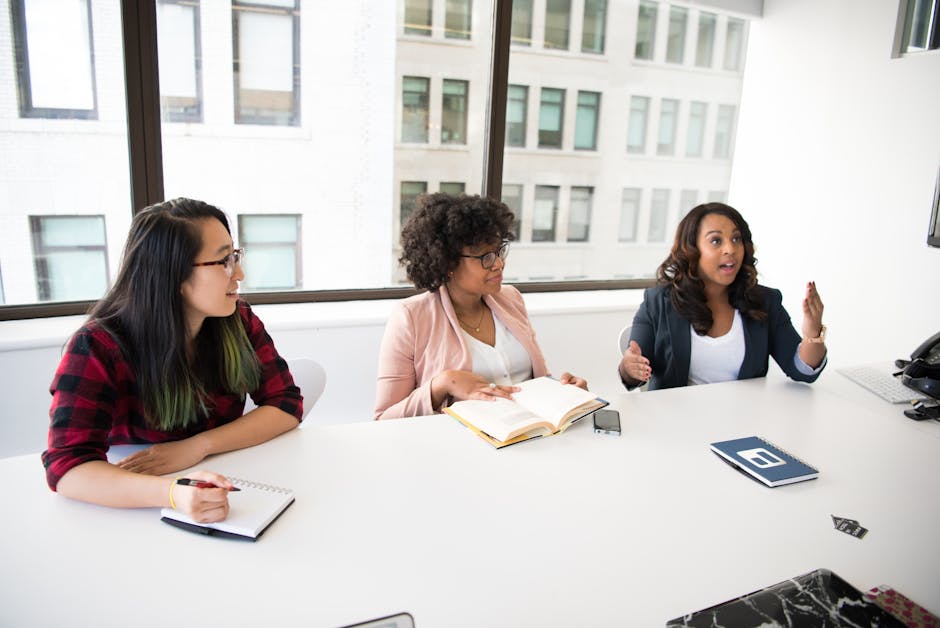 Diverse group of women collaborating in a bright modern office setting.