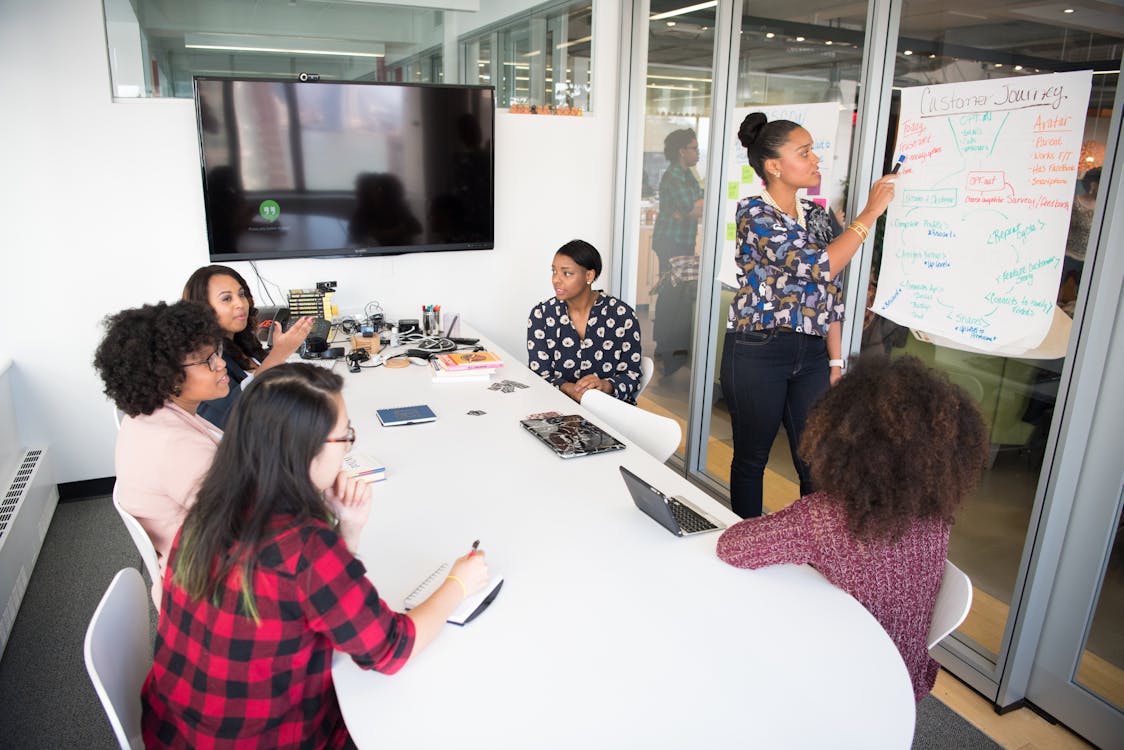 Free Women Colleagues gathered inside Conference Room Stock Photo