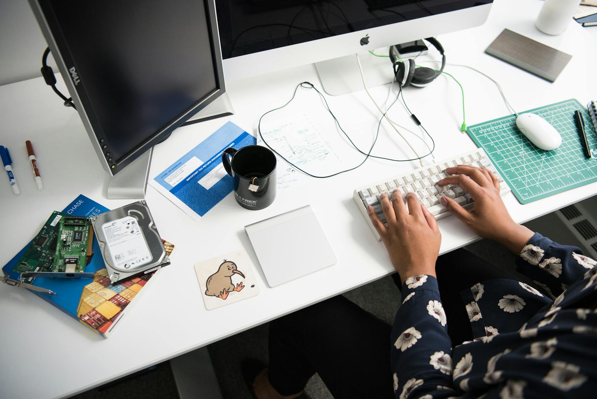 Person Typing on Corded Computer Keyboard Beside Apple Mighty Mouse