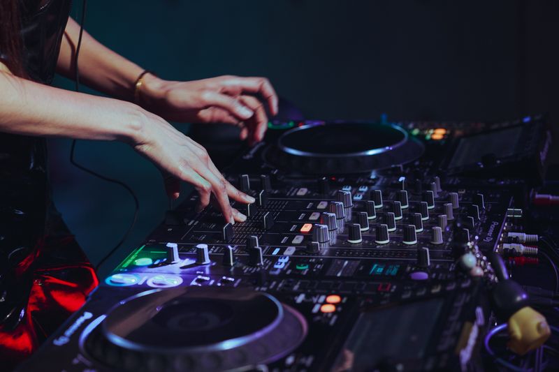 DJ Elena Vidal mixing on a professional console at night