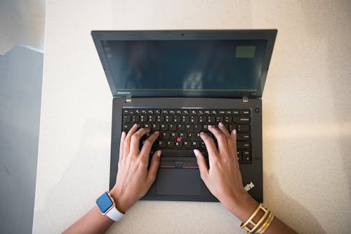 Human Hand on Black Lenovo Thinkpad