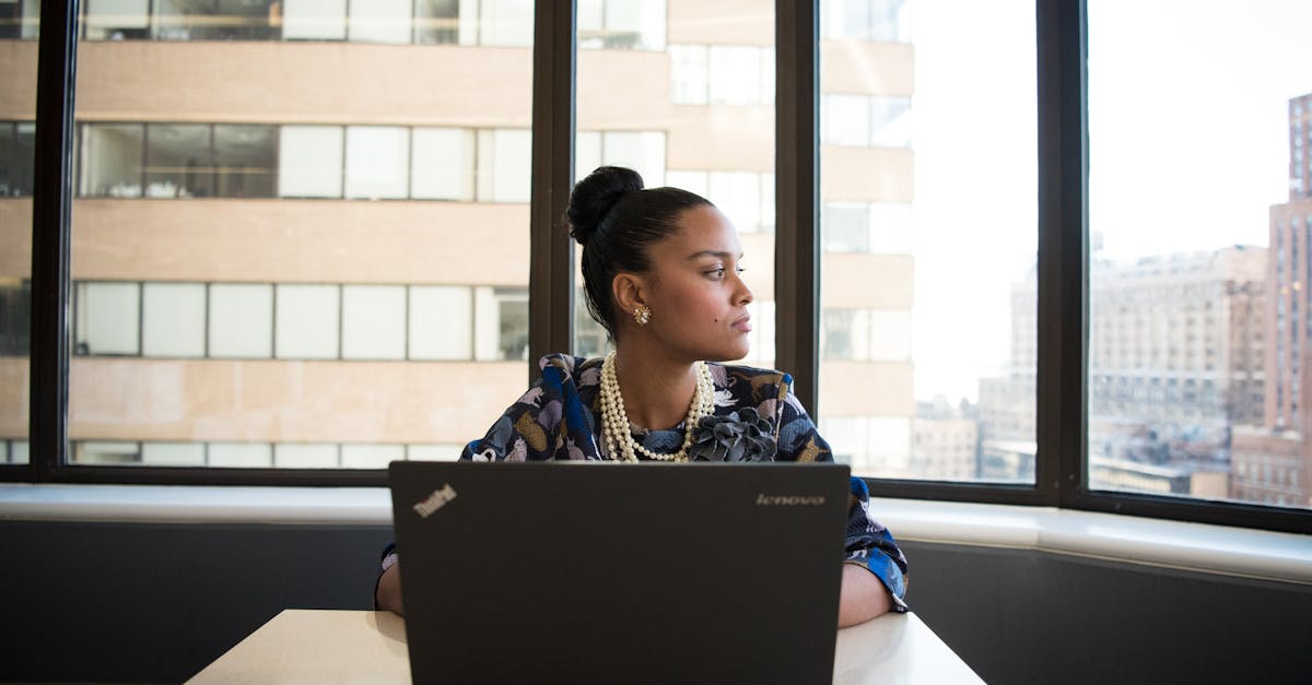 Woman Sits in Front of Black Laptop Computer