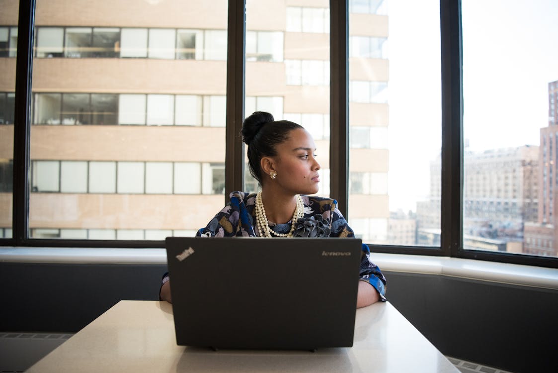 Free Woman Sits in Front of Black Laptop Computer Stock Photo