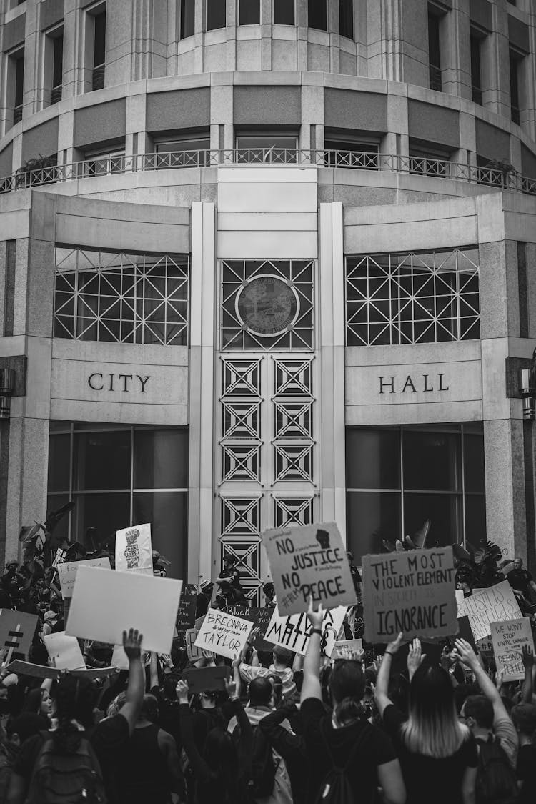 Black And White Photo Of Crowd Of People Protesting In Front Of City Hall