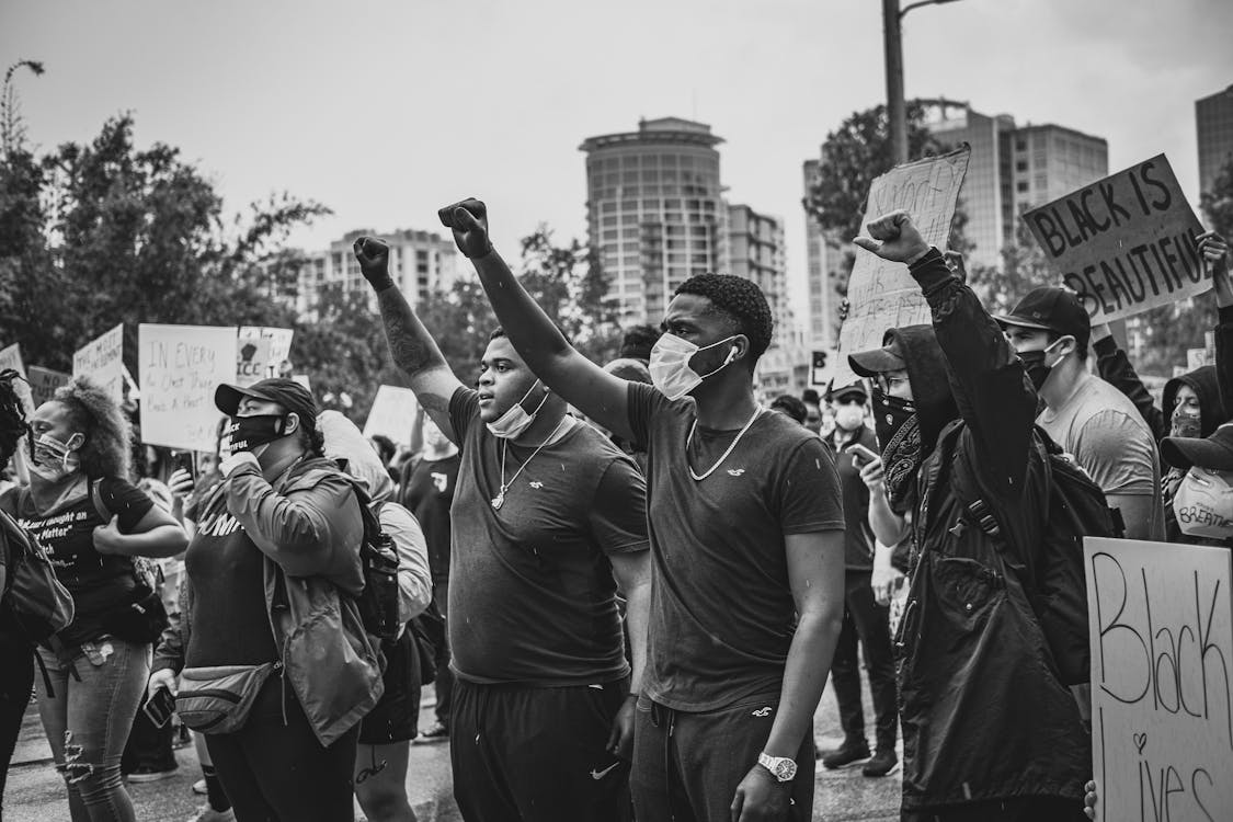 Grayscale Photo of People Protesting Together · Free Stock Photo