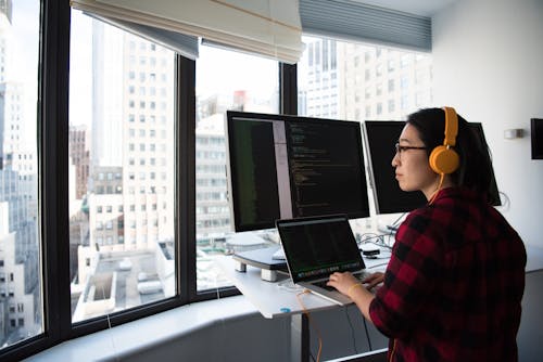 女人坐在同時操作macbook Pro