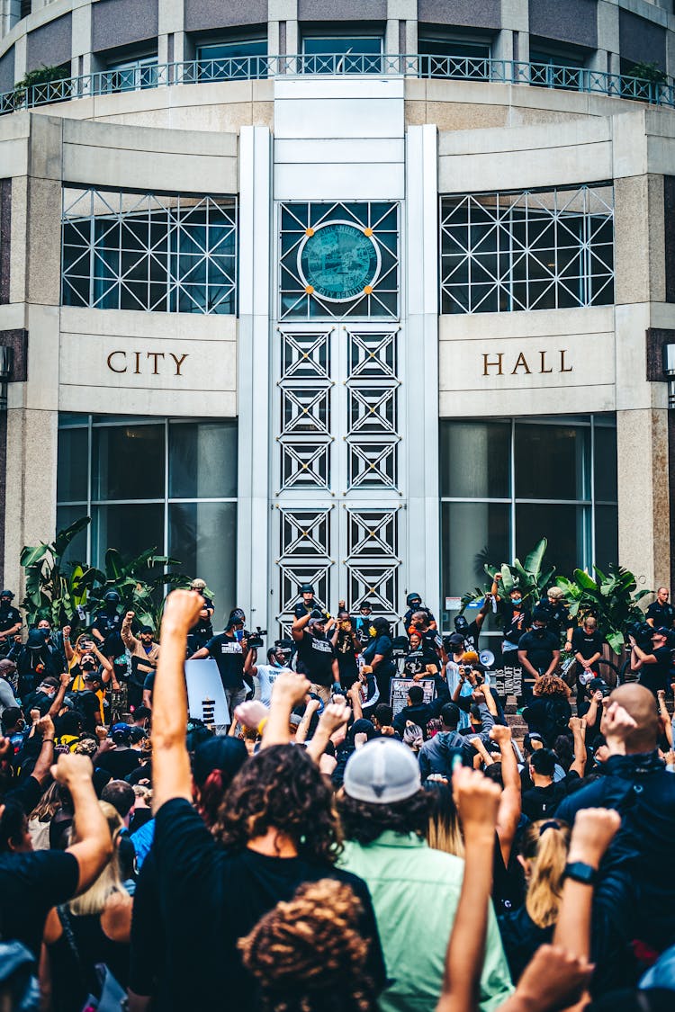 Crowd Of People Protesting In Front Of City Hall