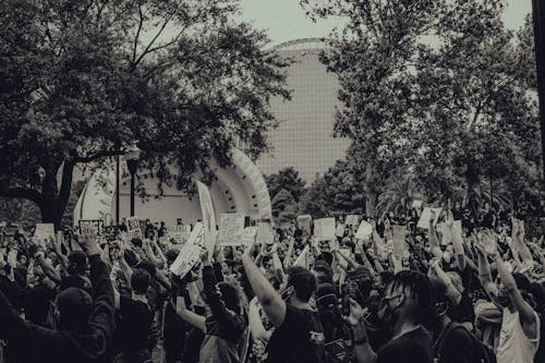 Grayscale Photo of Protesters Holding Placards