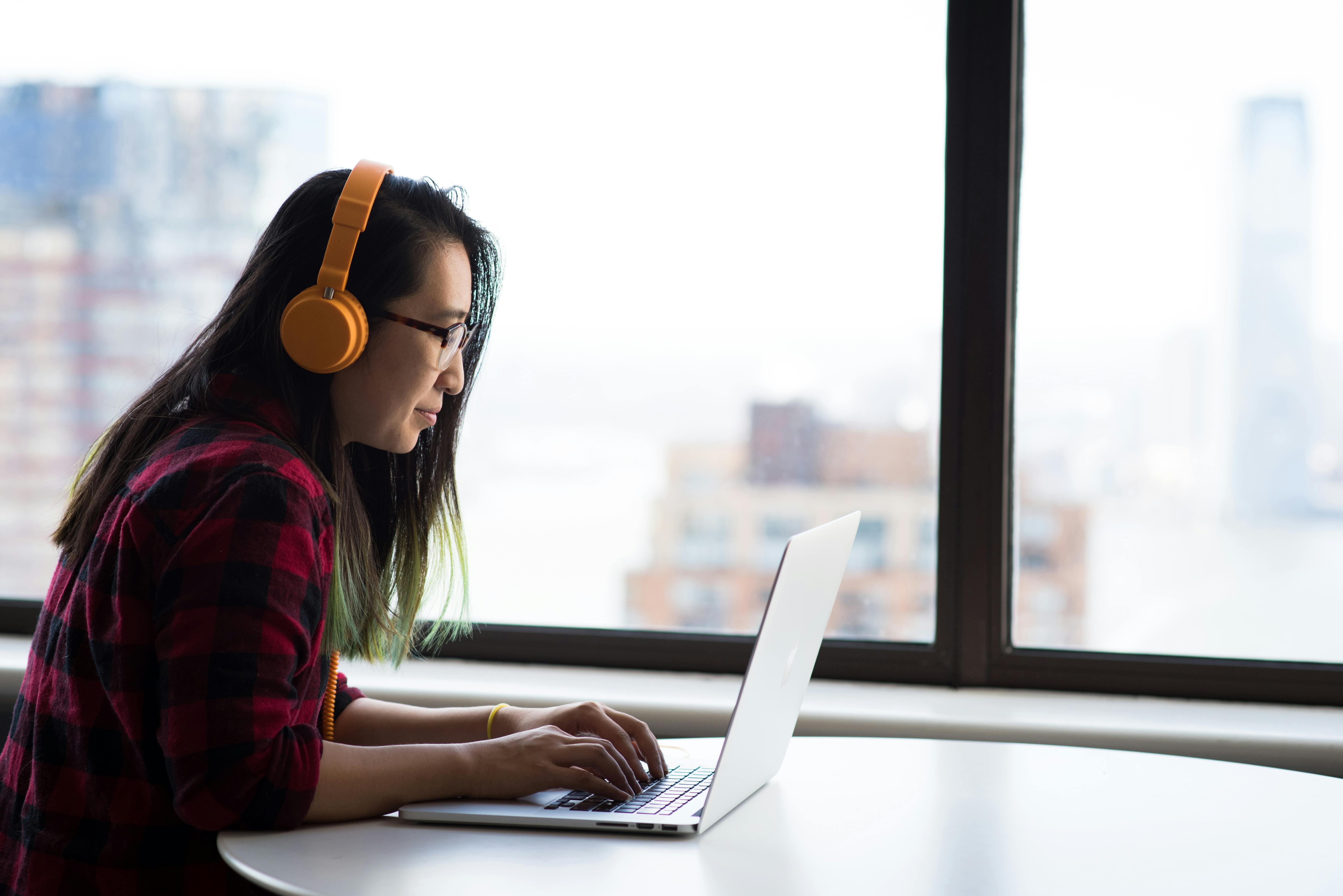 photography of woman using laptop