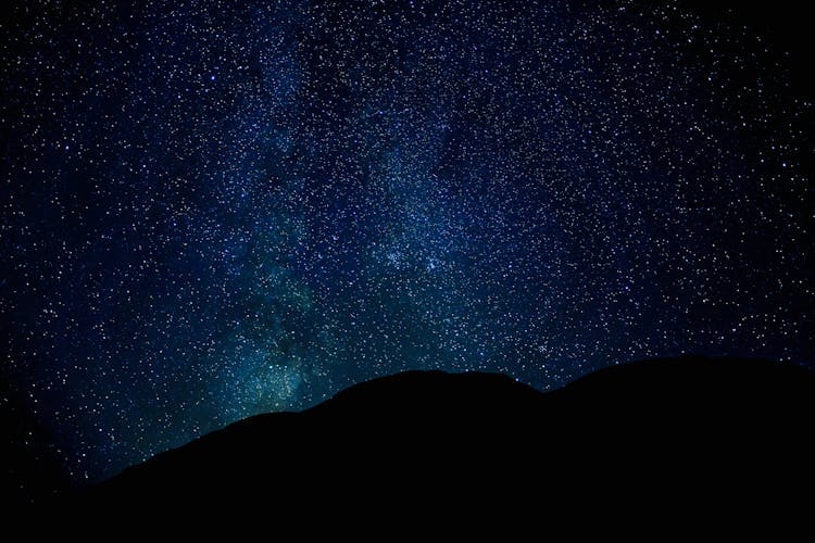 Silhouette Of Mountain Under Starry Night