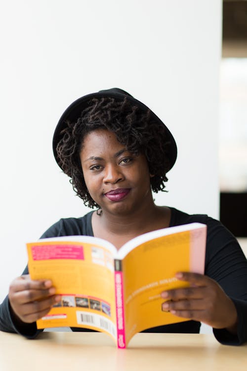 Woman With Black Hat Holding Book