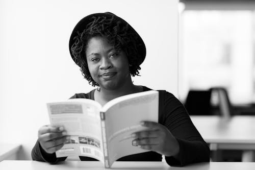 Monochrome Photography of Woman Reading Book