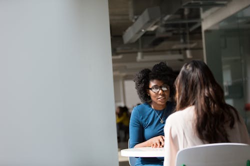 Free Woman Wearing Blue Top Beside Table Stock Photo