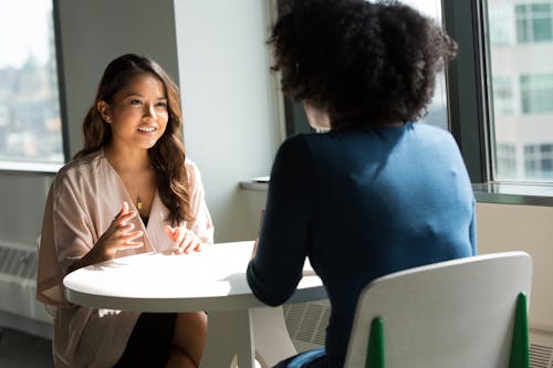 Free Man Wearing White Top in Front of Woman Wearing Blue Long-sleeved Top Stock Photo