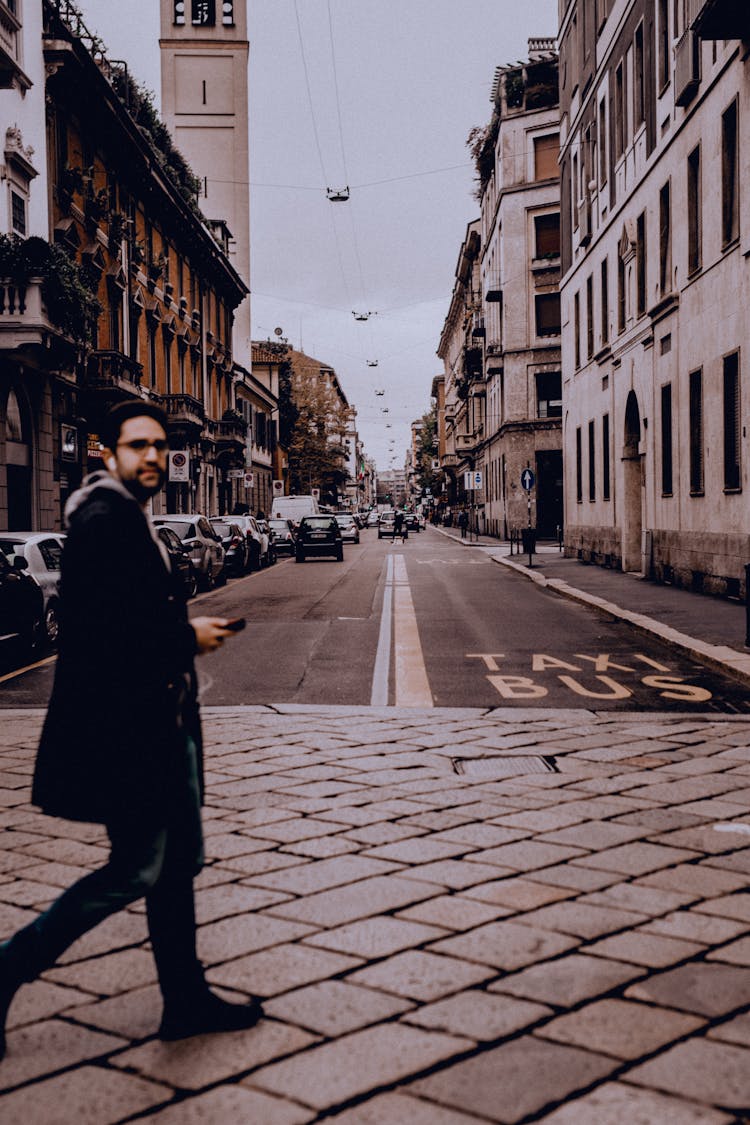 Man Crossing Old City Street