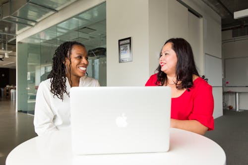 Free Two Women in Front of Silver Macbook Stock Photo