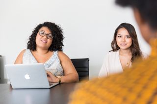 Two colleagues talking over a laptop — photo by Christina Morillo on Pexels