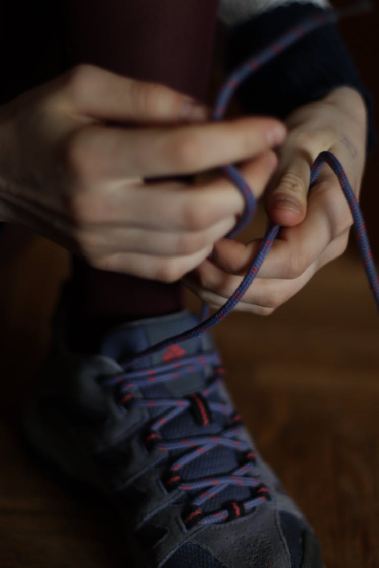 A Person Tying Shoe Lace