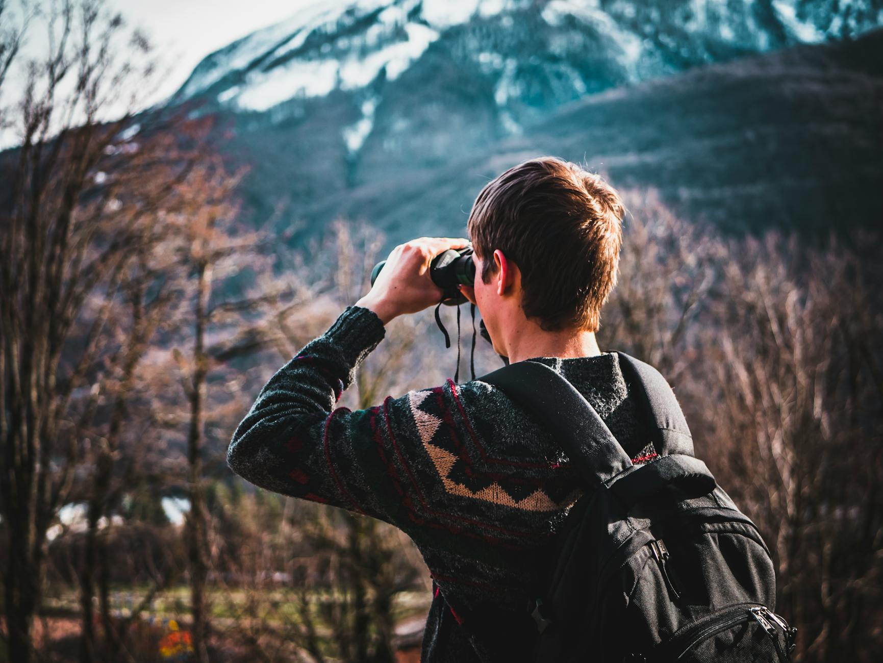 man using black binoculars 