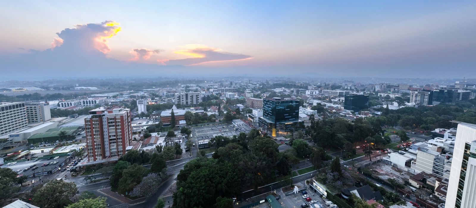 Panoramic aerial view of Guatemala City during sunset, showcasing urban landscape and skyline. — flights from Mexico City to Guatemala City