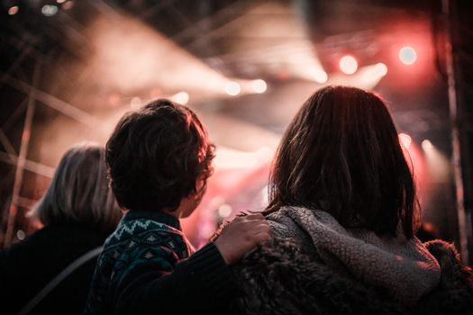 Crowd enjoying a concert with dynamic stage lighting in A Coruña, Spain.