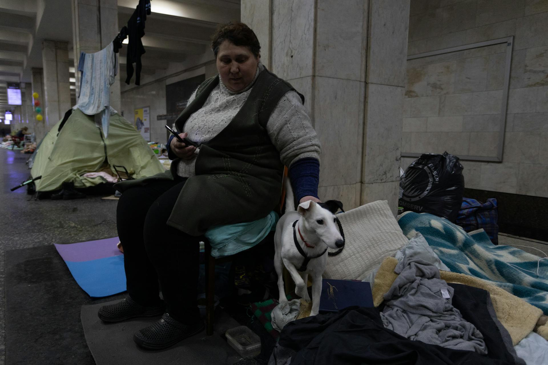 A Woman in a Shelter with Her Pet Dog