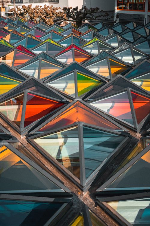 Free Colorful geometric glass panels create a modern architectural design. Stock Photo