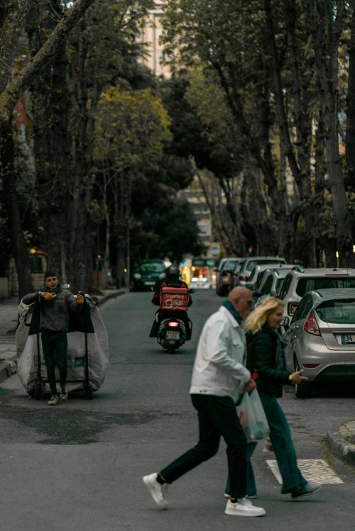 Free Busy street in İstanbul with people crossing and a motorbike passing by cars. Stock Photo