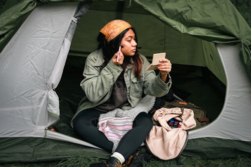 Free Woman in a Tent Putting Make-up Stock Photo