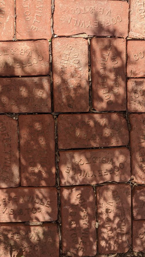 Free A detailed view of etched bricks under dappled sunlight, revealing textured surfaces and shadows. Stock Photo