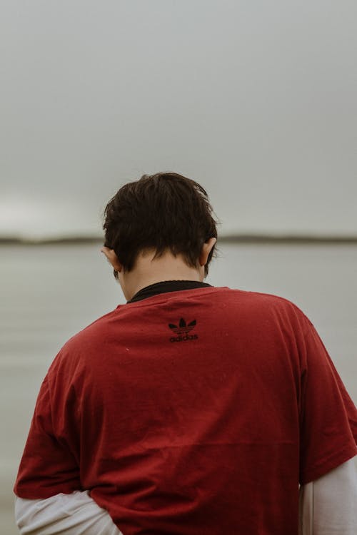 A Person Wearing a Red Adidas T-shirt
