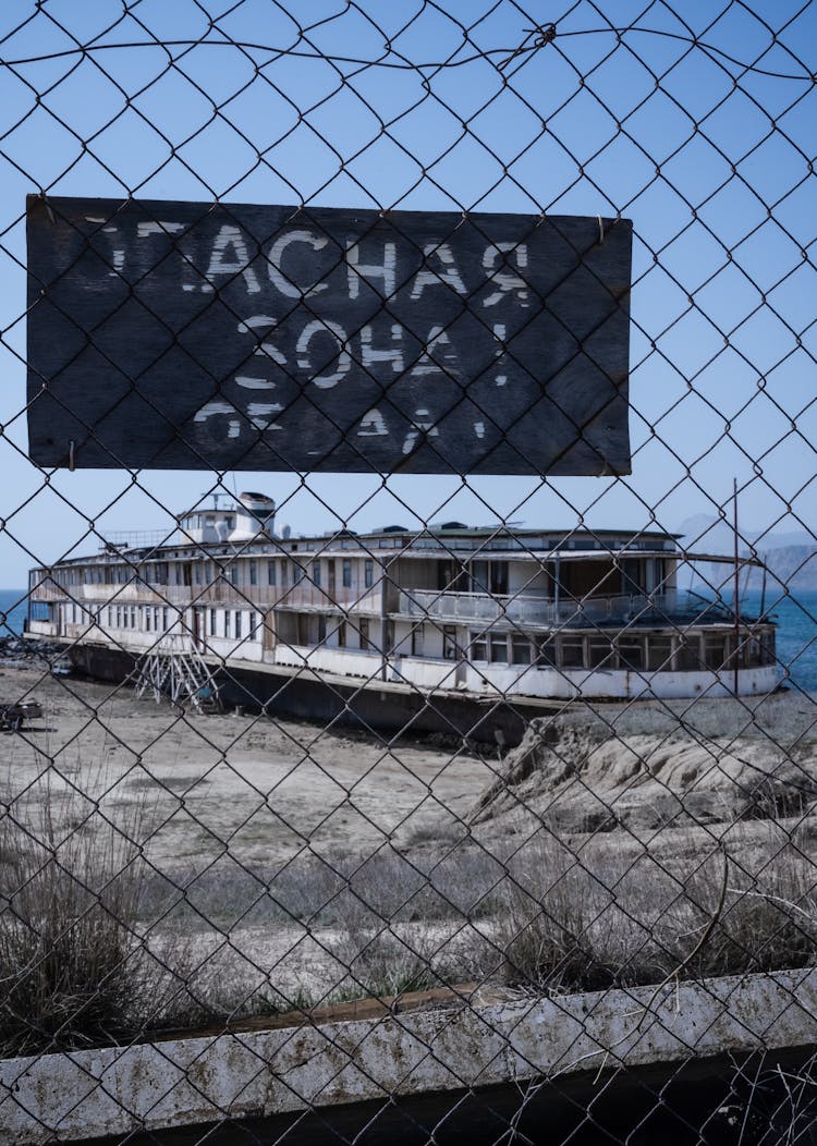 Abandoned Cruise Ship Behind Net