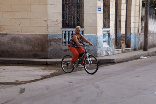 An Elderly Woman Riding a Bike 