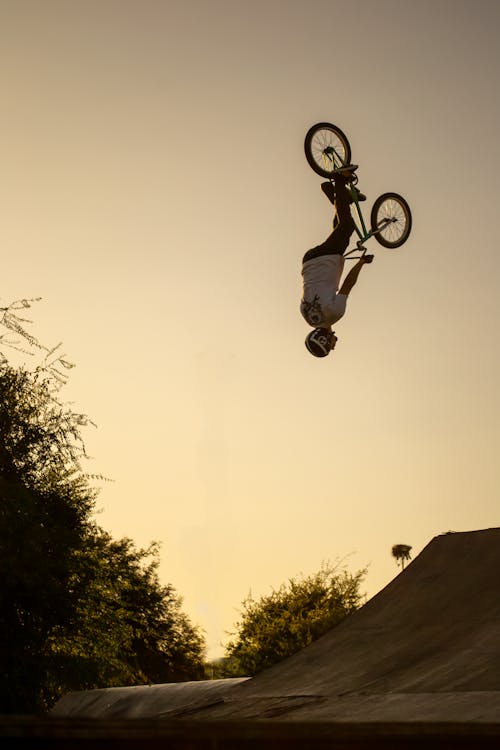 A Man Doing a Stunt with His BMX