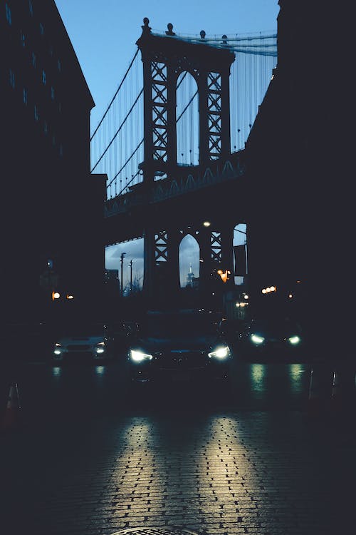 
Cars on a Street with Silhouette of the Brooklyn Bridge in the Background